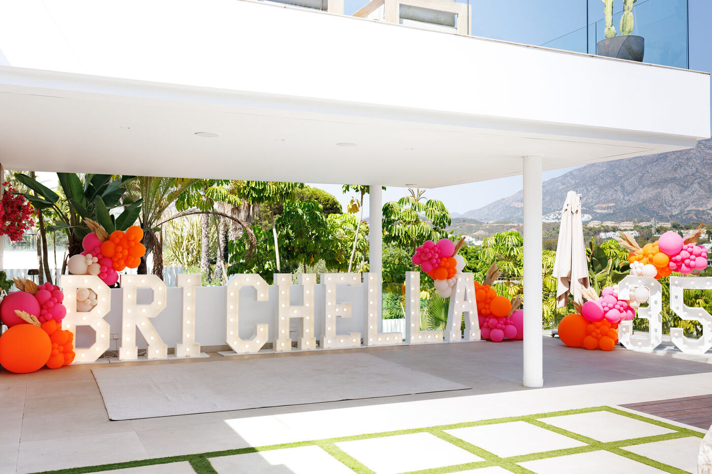 Styling pampas grass into a pink and orange balloon cluster, Marbella villa birthday
