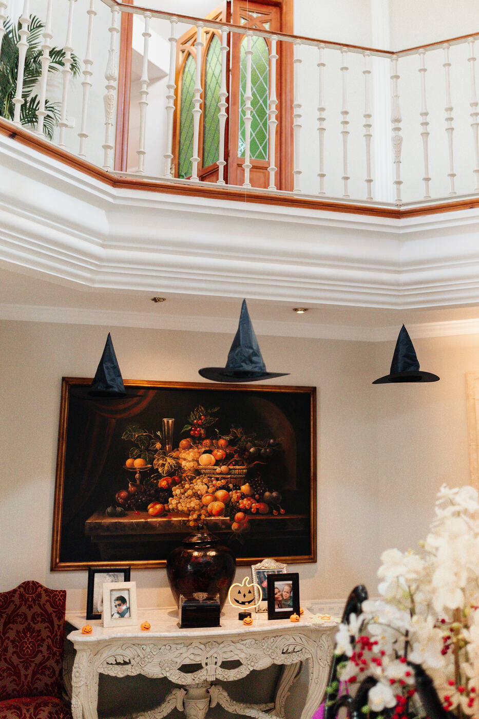 Floating witches' hats hanging from the ceiling in a villa hallway, Halloween decoration Marbella