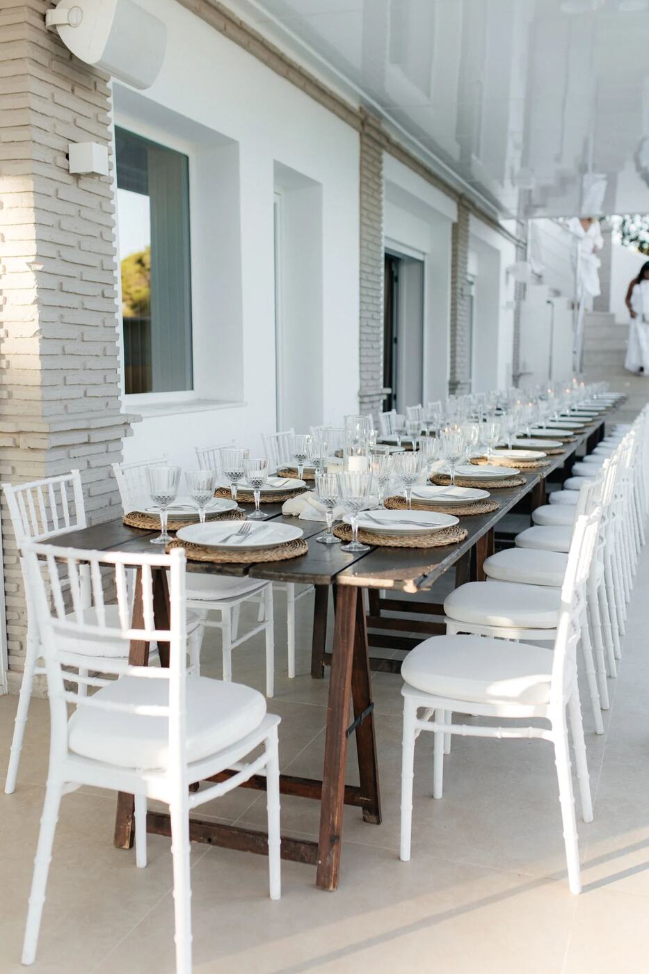 Long outdoor dinner table set for a private birthday party