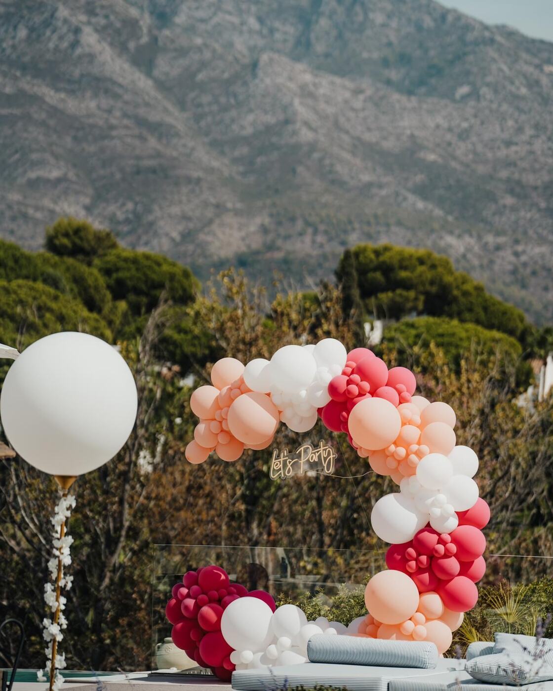 Coral balloon garland with Let's Party neon sign, Marbella