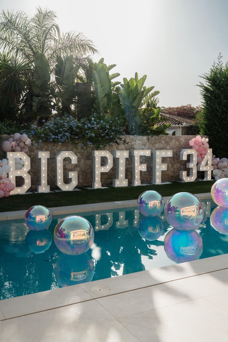 Giant iridescent pool orbz with BIG PIFF 34 marquee letters, Marbella